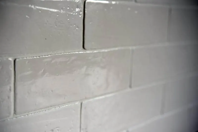 Glossy white rectangular wall tiles with contrasting grout