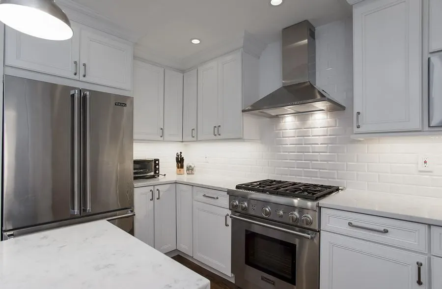 White kitchen with a glossy rectangular tiled backsplash
