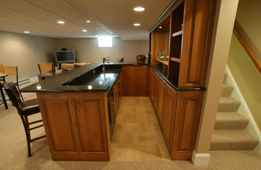 Kitchen with grey tiled flooring and wooden cabinets