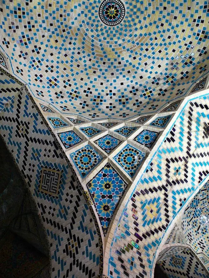 Blue, white and green mosaic tiles around a decorative interior corner