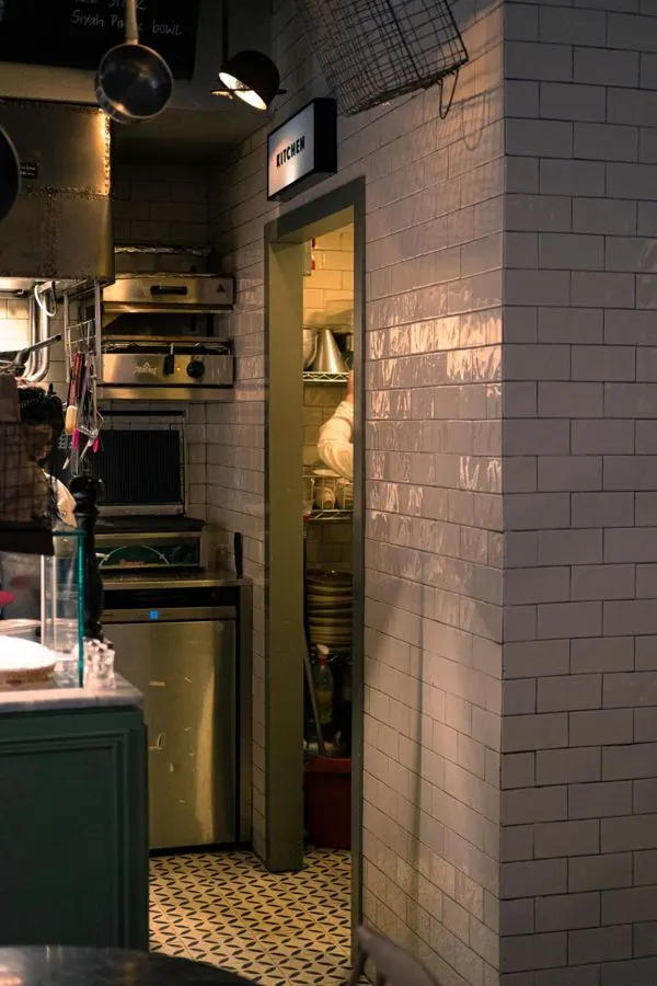 Pale textured tiles on a kitchen feature wall