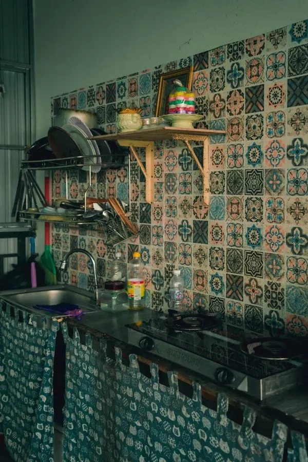 Kitchen backsplash with a mixture of green and beige decorative tiles