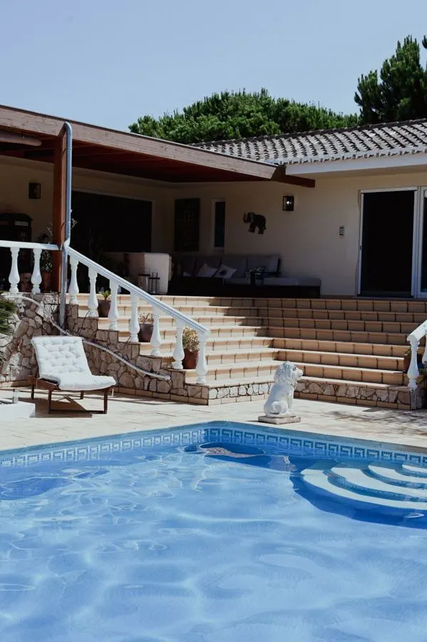 Villa courtyard with broad tiled steps beside a pool