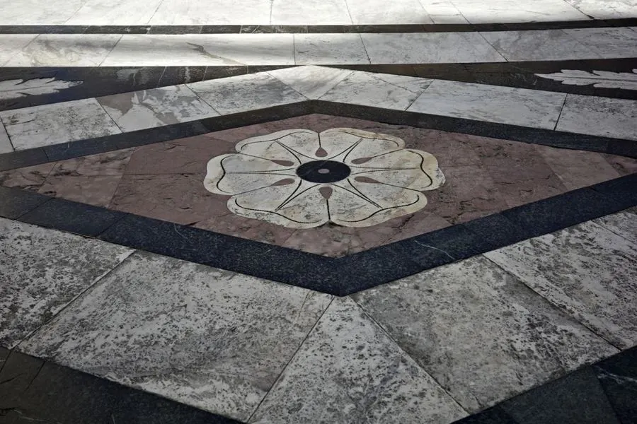 Geometric stone floor with a circular floral medallion