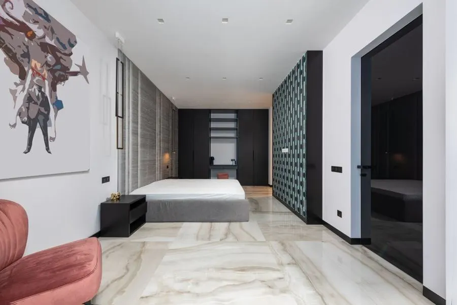 Modern bedroom with pale stone-pattern flooring