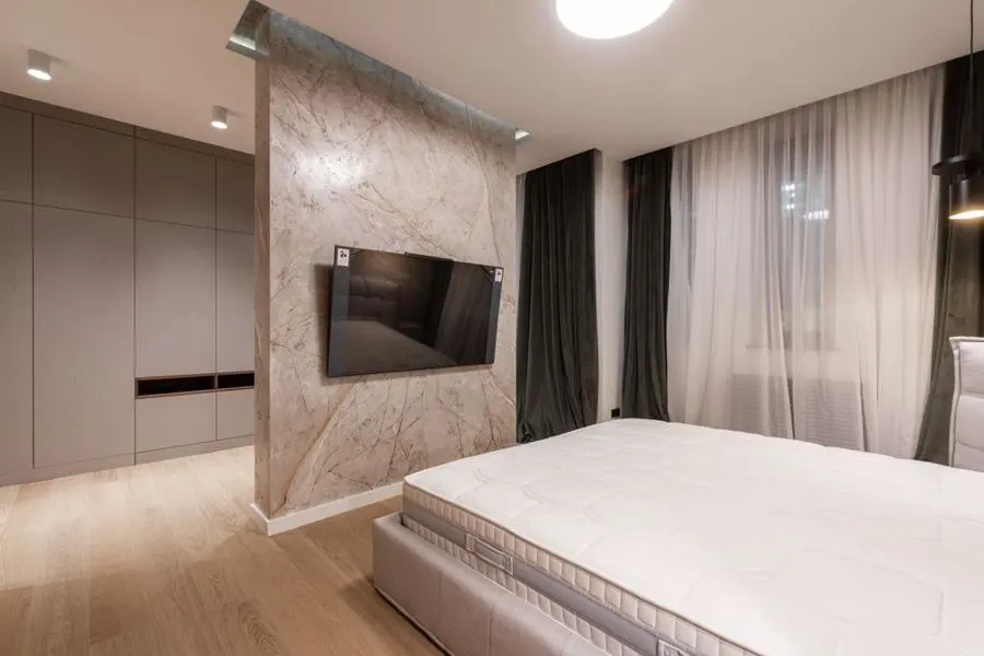 Bedroom with a stone-pattern television wall